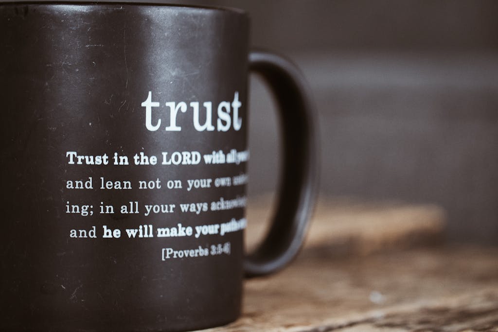 Black mug featuring the Bible verse from Proverbs 3:5-6 about trust and faith.