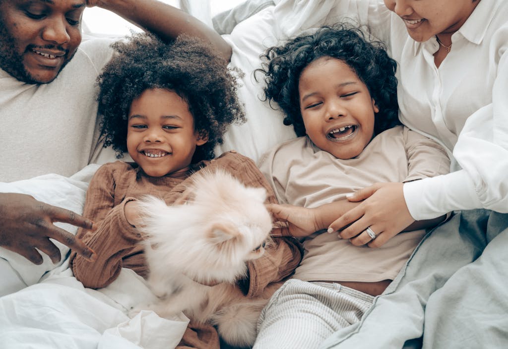 Joyful family enjoying time together with their pet dog on a cozy morning.